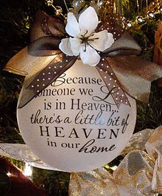 a christmas ornament hanging from a tree with a message on the front and back