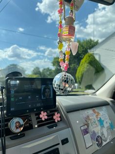 a car dashboard with a mirror ball hanging from it's ceiling and an mp3 player in the dash