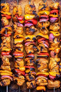 several skewers of meat and vegetables on a grill