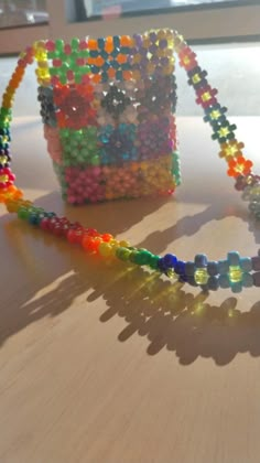 a beaded purse sitting on top of a wooden table