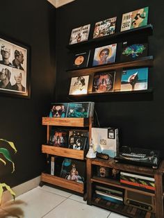 a record player is sitting on top of a shelf in a room with black walls