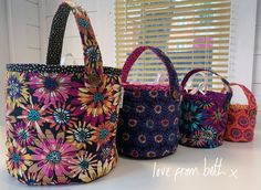 three colorful bags sitting on top of a table