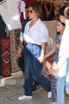 the woman is walking with two other women