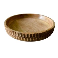 a wooden bowl with an intricate design on the rim