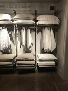 the bed and bath linens store is stocked with white sheets, blankets and pillows