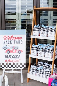 there is a sign that says welcome race fans to nikzai in front of the store