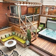 a hot tub sitting on top of a wooden deck next to a table and chairs