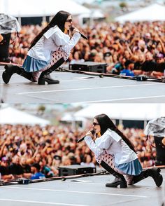 a woman in white shirt and blue skirt performing on stage with people watching her from the sidelines