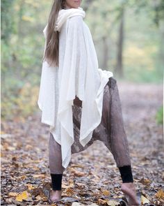 "Off White Knit Cotton Hooded Cape. Cowl Neck Hoodie. Poncho Style. This gorgeous soft tunic is lovingly handmade from an up-cycled cotton blend. It is a part of the collection \"Ceremony White\" - a collection of dresses and pants created specifically for your ceremony journeys, kundalini yoga, sound baths and mediation. Inspired by silent mediation and love for comfortable wear. Material: Up-cycled knit cotton. Very soft, light weight and flowing. Size: One size Overall Length: about 42 in. Ov Cozy White Stretch Cardigan, Cozy Stretch White Cardigan, Long Sleeve Poncho For Spring, Long Sleeve Poncho For Spring In One Size, One Size Long Sleeve Poncho For Spring, Cozy Long-sleeve Winter Cape, Cozy Long Sleeve Winter Cape, White Knit Poncho For Fall, Knitted Long Sleeve Poncho For Winter