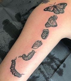 a woman's arm with butterflies on it and the word butterfly written in black ink