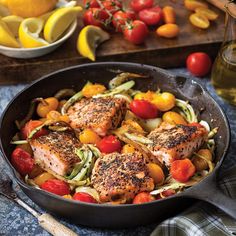 a skillet filled with chicken and vegetables