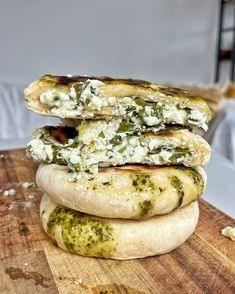 three pita breads stacked on top of each other with pesto and cheese