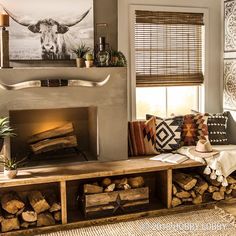 a living room filled with furniture and a fire place next to a wall mounted cow