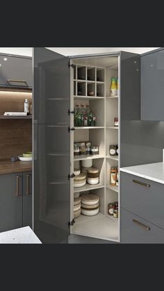 an open pantry in the middle of a kitchen with lots of cupboards and drawers