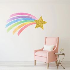 a pink chair sitting in front of a wall with a rainbow painted star on it