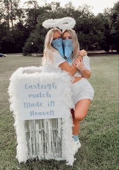 two women hugging each other in front of a sign with words on it that says, curfeef math made in heaven