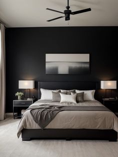 a bedroom with black walls and white bedding