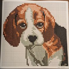 a beagle dog is shown in this cross stitch pattern