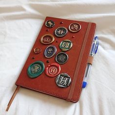 a notebook covered in lots of different types of buttons