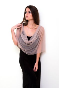 Step into a world of understated elegance with our Beige Sheer Loop Shawl - a captivating and lightweight accessory that effortlessly enhances your look in four different ways: as a shrug, shawl, crisscrossed shawl, or scarf. The versatile beige hue combined with sheer fabric exudes sophistication, making it a perfect choice for various occasions. Available in three sizes for a flawless fit: Petite (US 0-6) One size (US 8-14) Plus size (US 14-22) This exquisite shawl comes with wearing instructions, beautifully presented in a printed gift bag, making it a thoughtful and charming gift option for your loved ones. Additionally, we've thoughtfully included a QR code linked to the movie clip, granting you easy access to styling ideas. Experience the elegance in our YouTube clip: http://www.yout Pink Shawl, Sheer Cover Up, Shrug For Dresses, Evening Shawls, Bridal Bolero, Beige Stone, Shrugs And Boleros, Bridal Shawl, Loop Scarf