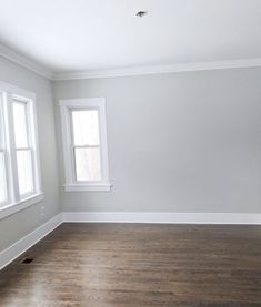 an empty room with hard wood floors and white paint on the walls is shown in this image