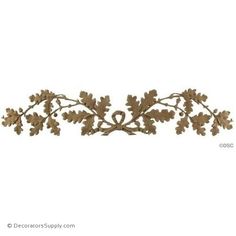 an ornate metal wall decoration with leaves and acorns