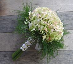 a bridal bouquet with white and green flowers