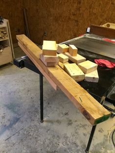 some blocks of wood sitting on top of a workbench in a garage area