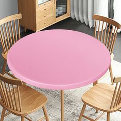 there is a pink table and chairs in the room