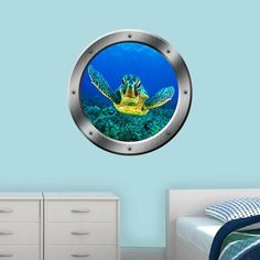 a sea turtle looking through a porthole wall decal in a bedroom with blue walls