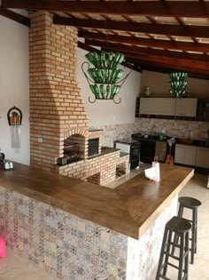 a kitchen with an oven, counter and stools