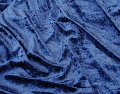 an image of a blue velvet fabric textured with it's folds and wrinkles