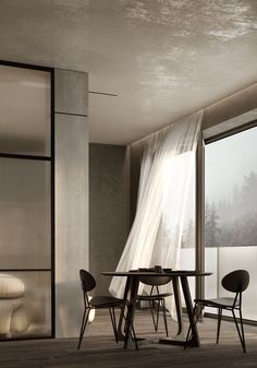 a table and chairs in front of a window with sheer curtains on the windowsill