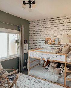 a child's bedroom with two bunk beds and a rocking chair in the corner