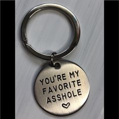 a metal keychain that says, you're my favorite ashhole