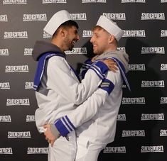 two men in sailor costumes hugging each other