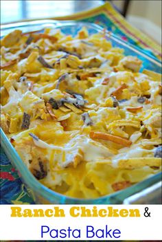 a casserole dish with chicken and pasta in it on a colorful table cloth