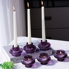 purple candles sitting on top of a white table