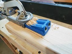 a pair of scissors is sitting on top of a piece of wood that has been planed