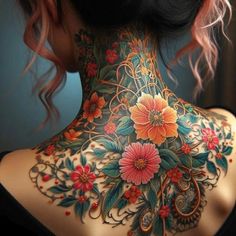 a woman's back neck with flowers and vines on the upper part of her body