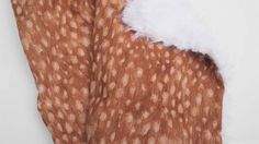 the fabric is brown and white with spots on it's side, along with fur