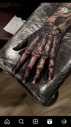 a person's hand with tattoos on it