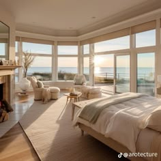 a bedroom with a fireplace and large windows overlooking the ocean in front of it is shown