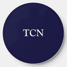 a black and white clock with the word tcn in it's center, on a blue background