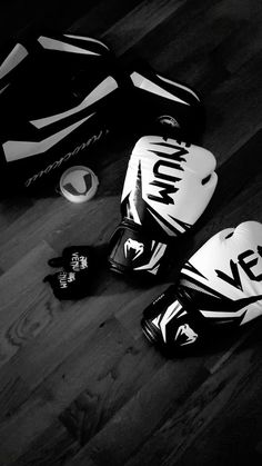 black and white photograph of boxing gloves on the floor