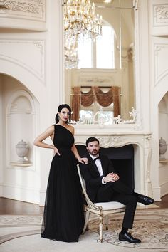 a man in a tuxedo and a woman in a black dress pose for a photo