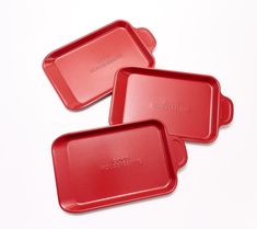 three red plastic trays sitting next to each other