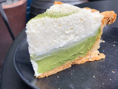 a piece of cake with green and white frosting on it sitting on a plate