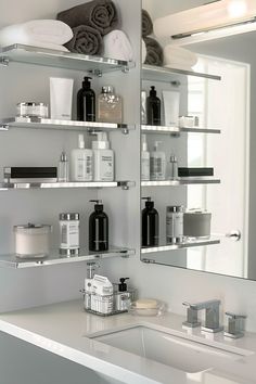 a white bathroom with shelves filled with personal care items