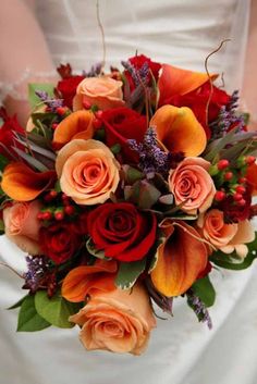 a bridal bouquet with orange and red flowers